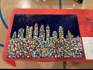 TNC student painting of a cityscape using pointillism