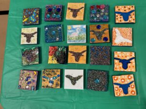 TNC student painted tiles featuring Longhorns and glitter