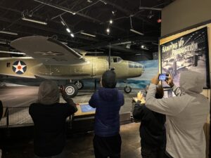 MCH students take photos of a WWII plane at the Nimitz Museum