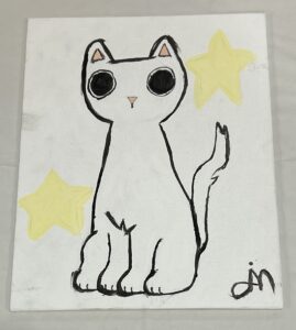 student drawing of a cat. Black ink on white paper. The cat is distinct because it's eyes are black and wide. The cat's ears and nose are pink.