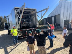 Pathfinders students look at equipment in a truck during the career fair