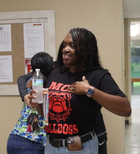 A teacher displays her MCH Bulldogs T-shirt