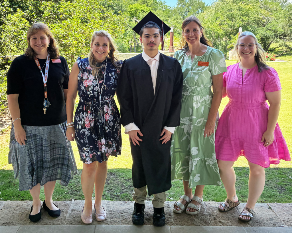 Jeremy, in cap and gown, with UTCS staff